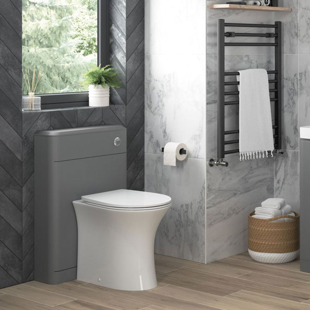 White back-to-wall toilet installed against fitted bathroom furniture